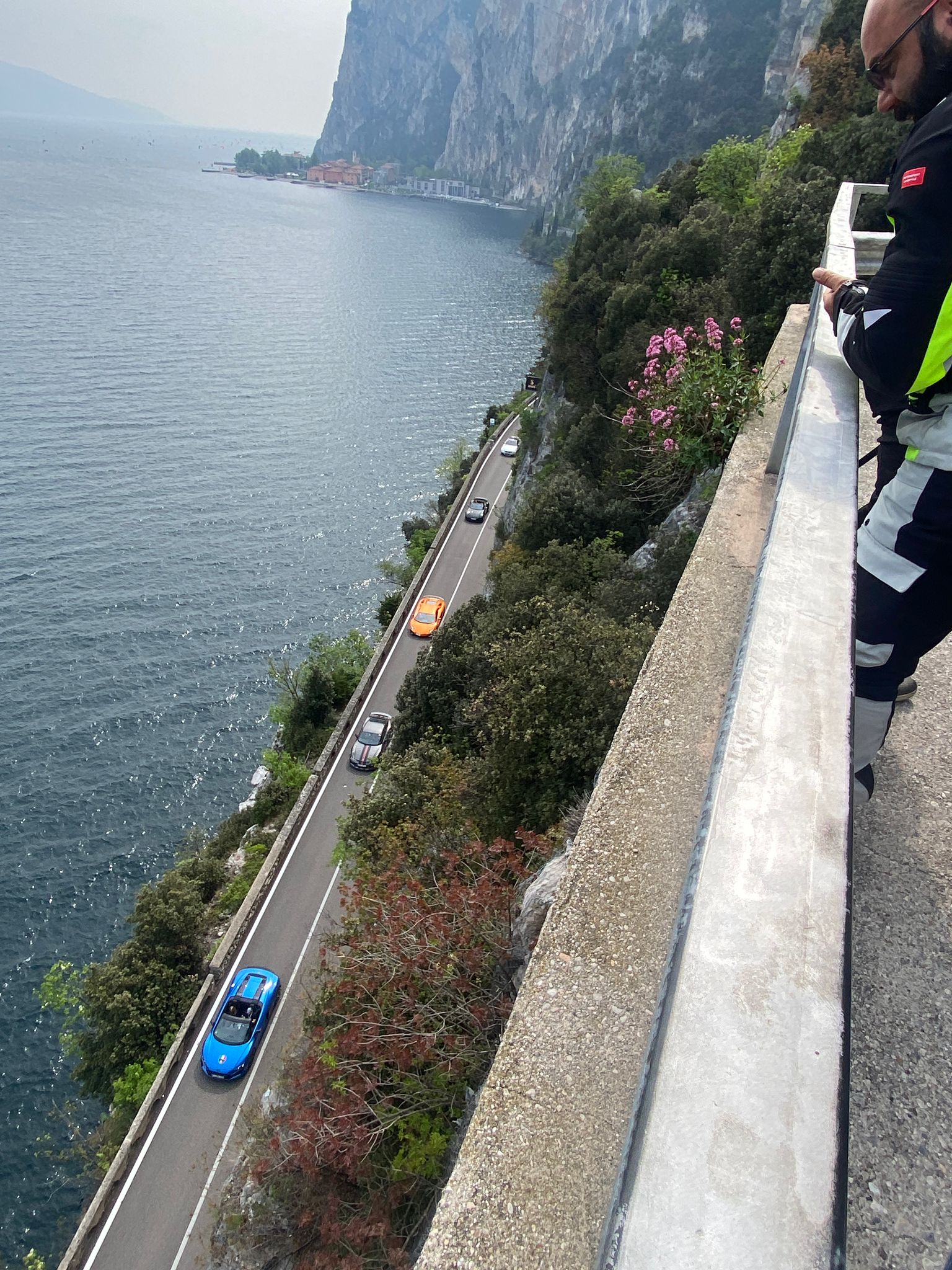 A sports car following the cliffside road above Lake Garda on a previous Italian journey